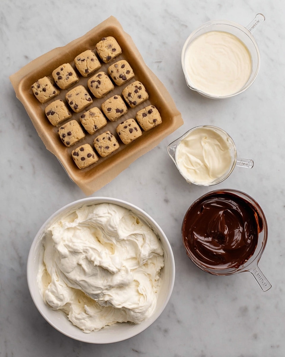 The image shows four ingredients on a white marbled surface: a square tray lined with brown paper holding 24 small, light brown cookie dough pieces with dark specks arranged neatly in four rows and six columns at the top left; above right, a measuring cup with smooth, white cream filling; below right, a measuring cup filled with thick, shiny dark chocolate; at the bottom left, a large white bowl filled with fluffy white whipped cream with soft peaks. Photo taken with an iphone --ar 4:5 --v 7