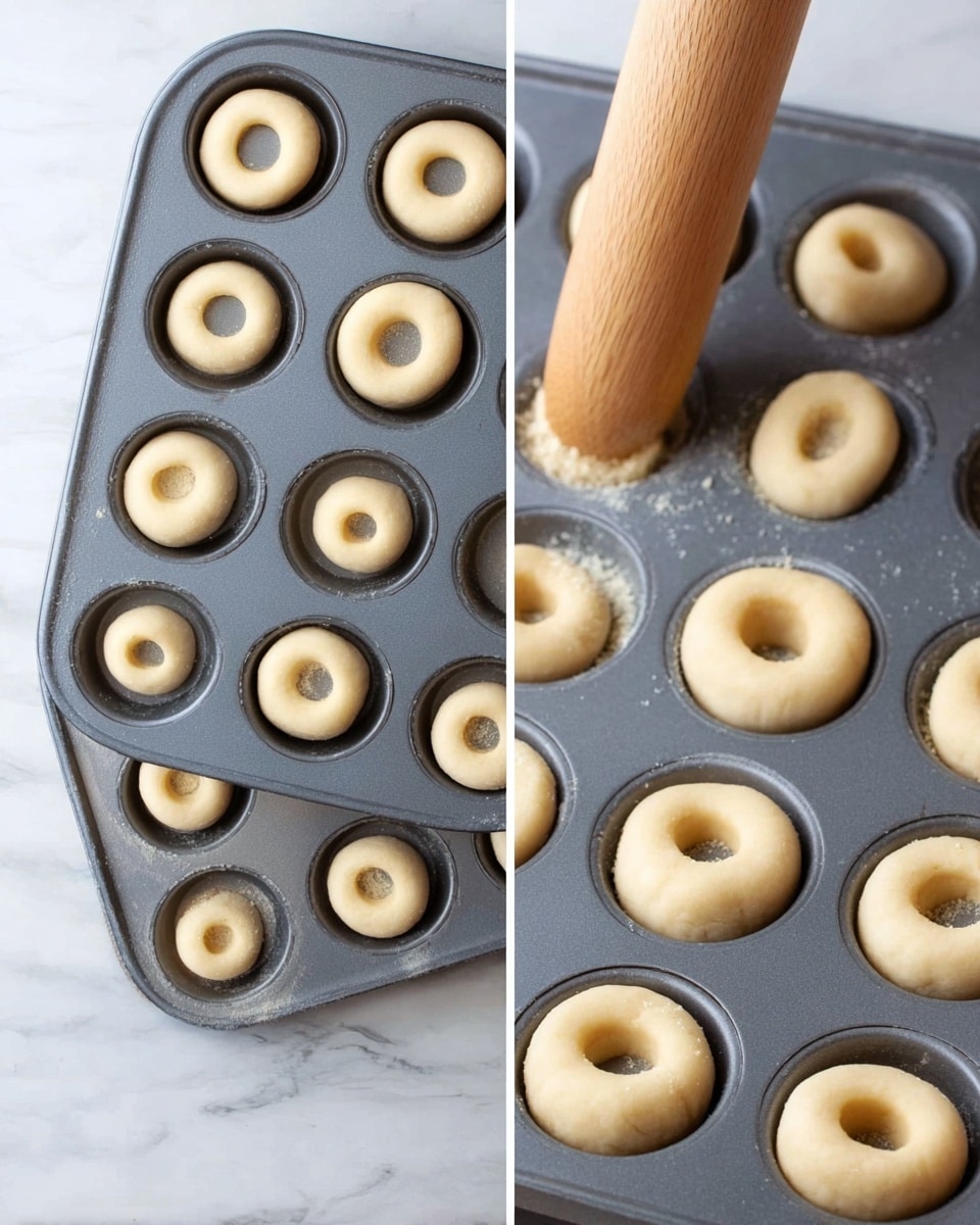 The image shows a dark grey muffin tray with 24 round dough pieces placed inside each section, their color is light beige and they have a smooth texture. On the top right, there is a wooden tool pressing down the dough in one section, forming a hollow center. On the bottom right, the dough pieces all have a clear round hole pressed in the middle, giving them a two-layer look: the outer dough ring and the hollow center. The tray is set on a white marbled surface. photo taken with an iphone --ar 4:5 --v 7