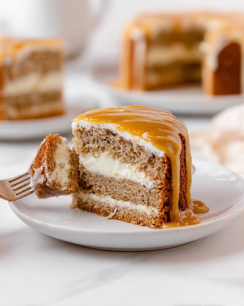 The image shows a small round cake with four visible layers of light brown sponge separated by three thin layers of creamy white filling. The top layer is covered with a smooth caramel-colored sauce that drips down the sides. A piece of cake is lifted slightly by a fork held by a woman's hand, revealing the soft texture inside. The cake sits on a simple white plate on a white marbled surface, with a blurred background showing another similar cake and soft light coming from behind. Photo taken with an iphone --ar 4:5 --v 7