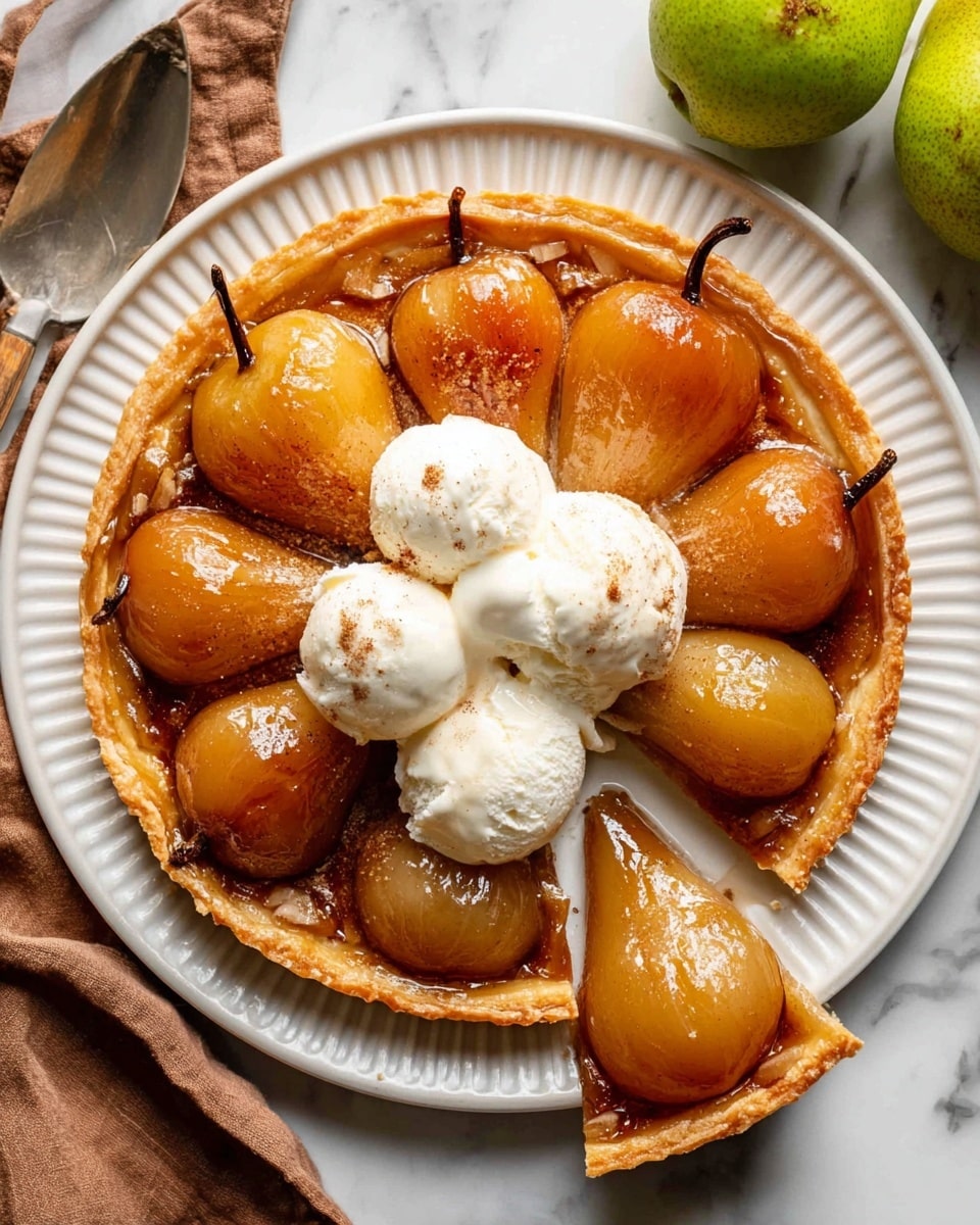 The image shows a round pear tart with a light golden brown pastry crust that looks flaky and slightly crimped at the edges. Inside, there are eight whole poached pears arranged in a circle, each one shiny with a caramelized glaze and sprinkled lightly with cinnamon, giving a warm orange-brown color and smooth texture. In the center of the tart, there are three scoops of creamy white ice cream, melting slightly over the pears. One slice of the tart is partially cut and slightly pulled out, revealing the thick, tender pears and the soft crust underneath. The tart is on a white plate with fine ridges, placed on a white marbled surface. A spoon with a wooden handle rests on the edge of the plate. Nearby, two green pears and a brown cloth are partially visible. photo taken with an iphone --ar 4:5 --v 7
