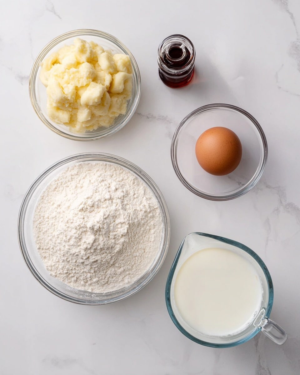 The image shows five clear glass bowls and containers placed on a white marbled surface. At the center, there is a large bowl filled with white flour that has a soft, powdery texture. To the left, a smaller bowl holds mashed bananas with a creamy, slightly chunky texture in a pale yellow color. Above it is a tiny bottle with dark brown vanilla extract. On the top right, another small bowl contains a single brown egg with a smooth shell. Below it, on the bottom right side, is a measuring glass pitcher filled with white milk, showing a smooth liquid surface. The setup is clean and simple with each item visible and neatly arranged. Photo taken with an iphone --ar 4:5 --v 7