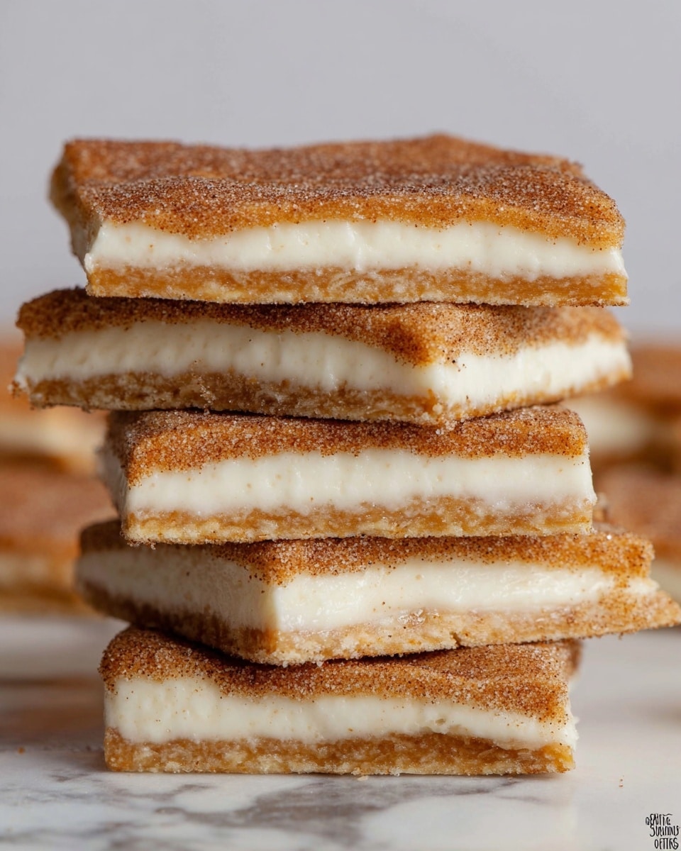 The image shows a close-up of a stack of five rectangular treats, each made with two layers of a crisp, golden brown crust with a rough texture, and a thick middle layer of smooth, white cream. The top surface of each treat is covered with a dusting of cinnamon sugar, giving a grainy brown look. The edges of the treats are slightly uneven, showing a homemade rustic feel. The treats are stacked unevenly on each other against a white marbled background. photo taken with an iphone --ar 4:5 --v 7