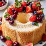 Elegant Angel Food Cake with Whipped Cream and Fresh Garnishes Recipe
