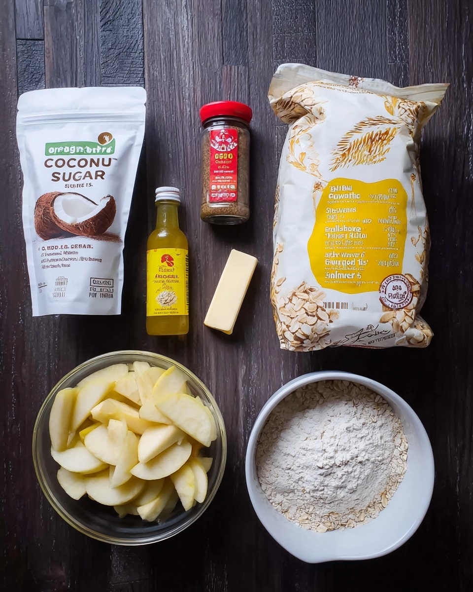 The image shows several baking ingredients arranged neatly on a dark wooden surface. From left to right, there is a white pouch of organic coconut sugar with a brown coconut image, a small clear spice jar with a red lid labeled ground cinnamon, a small yellow bottle of lemon juice, and a stick of butter with a beige wrapper. At the bottom left, there is a clear glass bowl filled with peeled and sliced apple pieces. At the top right, a white bowl contains white flour. Next to it is a large white bag of gluten-free sprouted rolled oats with yellow and brown text and oat illustrations. The whole setup is on a white marbled texture. photo taken with an iphone --ar 4:5 --v 7