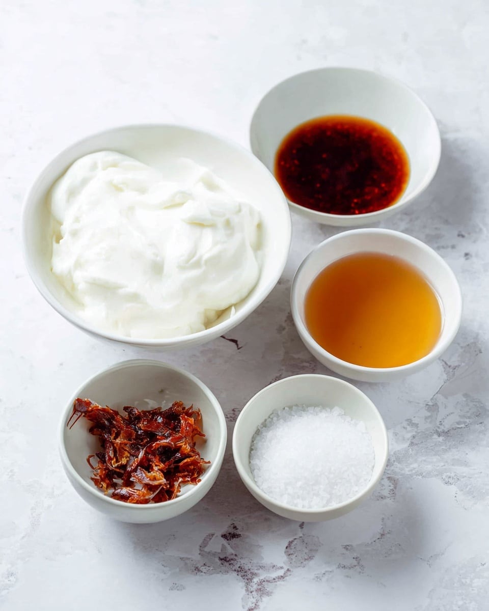 The image shows five small white bowls on a surface with a white marbled texture. The largest bowl is filled with a thick, white creamy substance that looks soft and smooth. Next to it, a bowl contains dark reddish-brown syrupy liquid with a shiny surface. Another small bowl holds a rough, dry ingredient with dark orange and burnt brown pieces. There is also a bowl with a clear golden amber liquid with a slight shine, and the last bowl has fine white granules, resembling coarse salt, with a matte texture. Photo taken with an iphone --ar 4:5 --v 7