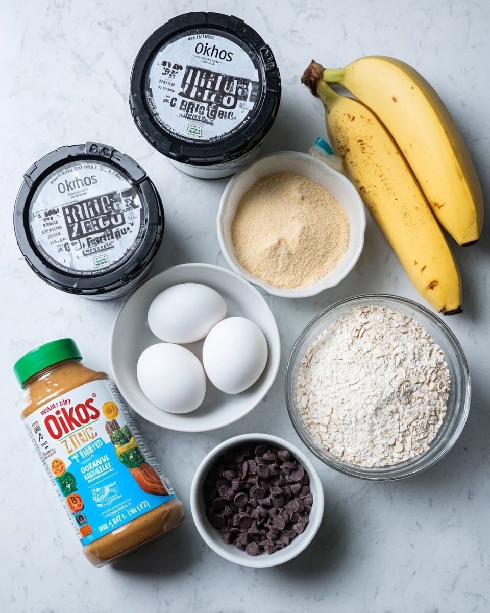 The image shows several ingredients arranged on a white marbled surface. There are two black and white yogurt containers with