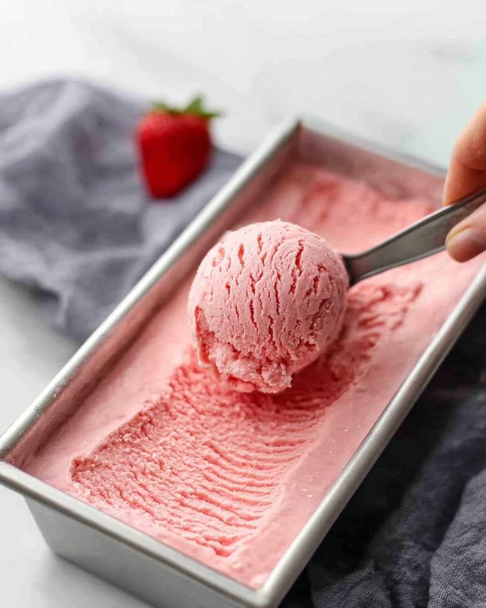 A rectangular metal pan filled with one thick layer of smooth, bright pink batter evenly spread inside. The pan sits on a white marbled surface next to a tray lined with plastic wrap holding extra batter. The texture of the batter looks soft and creamy with slight unevenness from spreading. Photo taken with an iphone --ar 4:5 --v 7