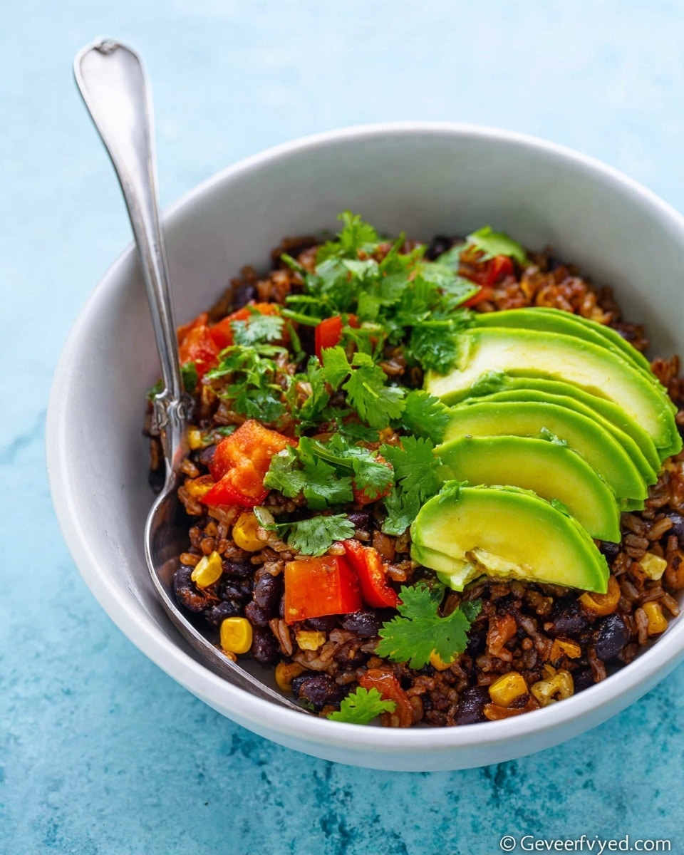 A white bowl filled with three main layers: the bottom layer is dark brown cooked rice mixed with small black beans and roasted corn kernels, the middle layer has chunks of red bell pepper and green avocado pieces, and the top layer is sliced light green avocado fanned out with green cilantro leaves scattered across. A silver spoon is placed inside the bowl on the left side. The bowl sits on a white marbled surface with a soft blue background. Photo taken with an iphone --ar 4:5 --v 7