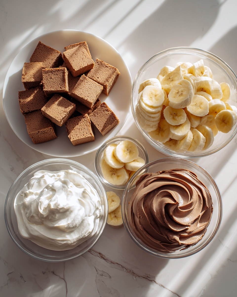 The image shows five containers of dessert ingredients arranged on a white marbled surface. On the left is a white plate piled with many small, soft brown cake squares. To the right of the plate, there is a clear glass bowl full of thick banana slices, yellow with a smooth texture, stacked neatly. Below this bowl, a smaller white bowl also holds some banana slices. In front of the cake squares and banana bowls, two clear glass bowls sit side by side; the one on the left contains a fluffy white whipped cream with soft peaks, and the one on the right holds a smooth, thick chocolate mousse with gentle swirls on top. The light casts soft shadows across the setup, and the photo was taken with an iphone --ar 4:5 --v 7
