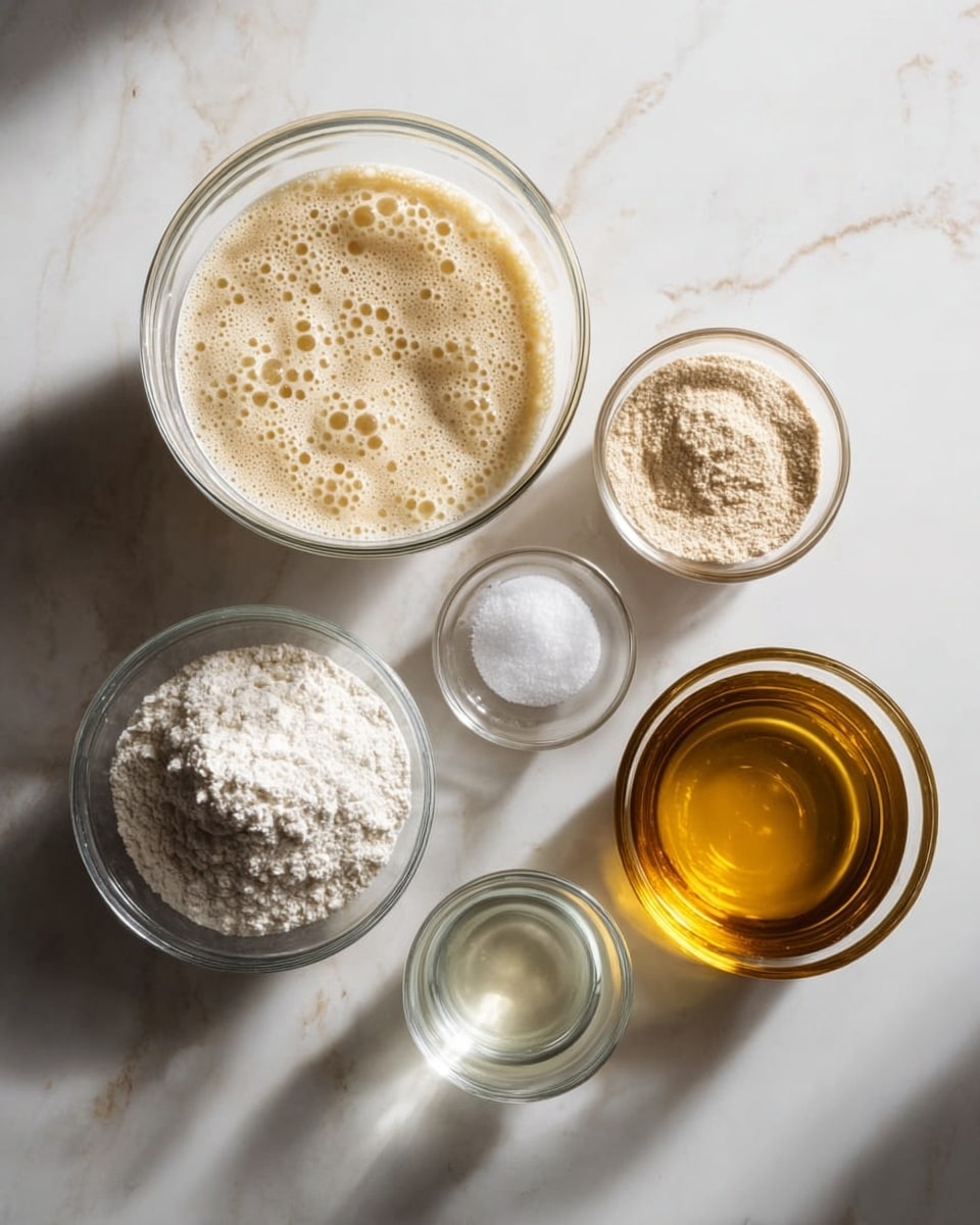 Six clear glass bowls are placed on a surface with a white marbled texture. The largest bowl in the center holds a bubbly, creamy beige mixture. To the right of it is a smaller bowl with a light brown powdery substance. On the far right is a bowl filled with a shiny golden liquid. On the left side of the big bowl, there is a bowl containing white flour and another smaller bowl with coarse white salt below it. Between the salt and the golden liquid is a bowl with a clear liquid. The light coming from the side creates soft shadows under the bowls. photo taken with an iphone --ar 4:5 --v 7