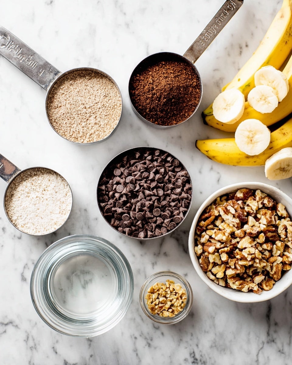 The image shows a white marbled surface with several measuring cups and a small bowl arranged closely. Starting from the top left, there is a metal measuring cup filled with light brown powder, followed by a smaller cup holding darker brown powder. Below them, there is a cup filled with dark brown chocolate chips, and to the left, a cup of fine white granulated sugar. Next to that, a cup holds chopped nuts in a mix of brown and beige shades. On the far right is a small white bowl filled with golden brown chopped nuts, and above it are slices of yellow bananas. In the center is a small clear glass bowl with water. All items on the white marbled surface are neatly arranged showing texture and color contrast. Photo taken with an iphone --ar 4:5 --v 7