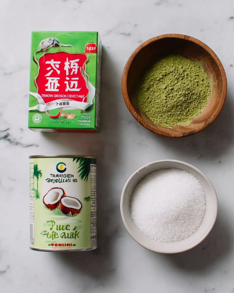 The image shows four food items arranged on a white marbled surface: on the left, there is a green box of pure gelatin with red and white design elements and Chinese text; in the middle, a can of Thai Kitchen organic unsweetened coconut milk with a red and green label featuring a coconut image; on the top right, a small wooden bowl filled with green powder; and on the bottom right, a white bowl filled with white granulated sugar. The items are spaced evenly in a simple, clean layout. photo taken with an iphone --ar 4:5 --v 7