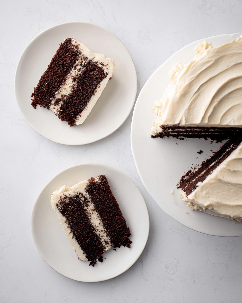 This image shows a chocolate cake with white cream frosting. There is a whole cake on the right side with smooth, light-colored frosting spread evenly on top and sides with soft swirls. Two white plates are placed to the left and bottom, each holding one slice of the three-layer chocolate cake. Each slice has two layers of white cream frosting between the dark brown cake layers, and more frosting covers the outer edges. The background is a white marbled texture. photo taken with an iphone --ar 4:5 --v 7