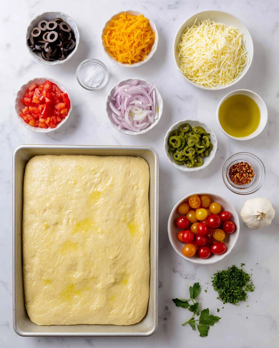 A baking tray holds a single, smooth, light yellow dough layer spread evenly with a slightly shiny surface. Surrounding the tray on a white marbled background are small white bowls arranged loosely in a grid pattern, each holding different chopped or shredded ingredients: dark green and red chopped peppers, shiny black and green sliced olives, finely shredded pale yellow cheese, grated white cheese, thin pinkish strips of onion, and halved cherry tomatoes in bright red and orange shades. Small bowls also contain coarse white salt, a golden liquid likely oil, and a small bowl of red chili flakes. Fresh green herbs and whole garlic sit near the bowls, with a few loose cherry tomatoes scattered around for a fresh look. Photo taken with an iphone --ar 4:5 --v 7