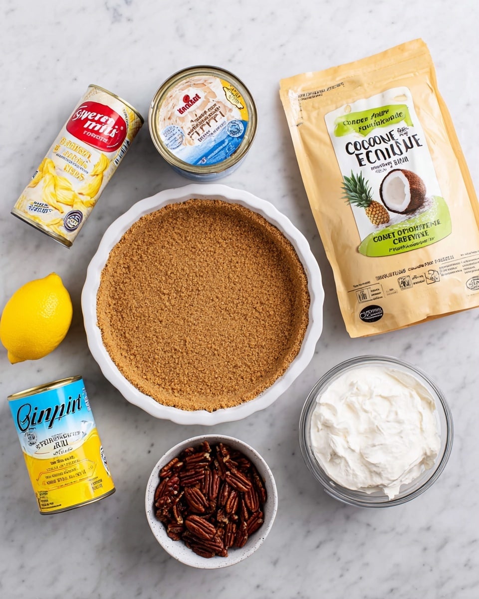 This image shows ingredients for a dessert laid out on a white marbled surface. In the center is a round graham cracker pie crust in a white pie pan, with a brown, crumbly texture. Above it, there is a can of sweetened condensed milk with a white label and a red top, next to a whole yellow lemon. To the right of the pie crust, there is a beige bag of unsweetened coconut flakes with green and brown text, showing a coconut picture. Below the crust, a white container of whipped topping with a blue label sits next to a small white bowl filled with dark brown pecan halves. To the left of the pie crust, there is a can of crushed pineapple in heavy syrup with a yellow and white label. The arrangement is neat and evenly spaced. photo taken with an iphone --ar 4:5 --v 7