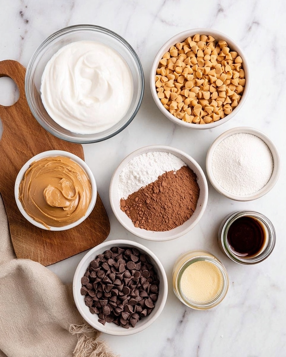 The image shows seven bowls and a small jar placed on a white marbled surface, each filled with different ingredients. From top left to bottom right: a clear glass bowl with soft white cream, a white bowl full of small golden peanut butter chips, a white bowl filled with white milk, a white bowl with light brown cocoa powder, a white bowl full of small dark brown peanut butter cup candies, a small clear glass bowl with light yellow powder, and a small clear jar with dark brown liquid, plus a small white bowl containing peanut butter placed on a wooden board on the left side. A beige cloth is partly visible at the bottom of the image, photo taken with an iphone --ar 4:5 --v 7