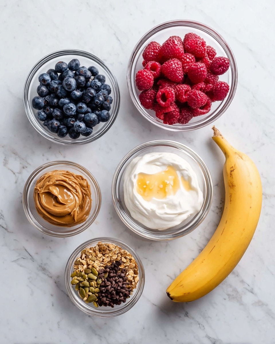 The image shows seven ingredients laid out on a white marbled surface. There are two medium-sized clear glass bowls at the top, one filled with deep blue blueberries on the left, and the other with bright red raspberries in the center. To the right is a larger clear glass bowl with a layer of white yogurt and golden honey on top. Below these, there are three smaller clear glass bowls, with light brown peanut butter on the left, golden brown granola with pumpkin seeds in the middle, and dark brown cacao nibs on the right. On the far right side of the image lies a whole yellow banana. The arrangement is neat and spaced evenly. Photo taken with an iphone --ar 4:5 --v 7