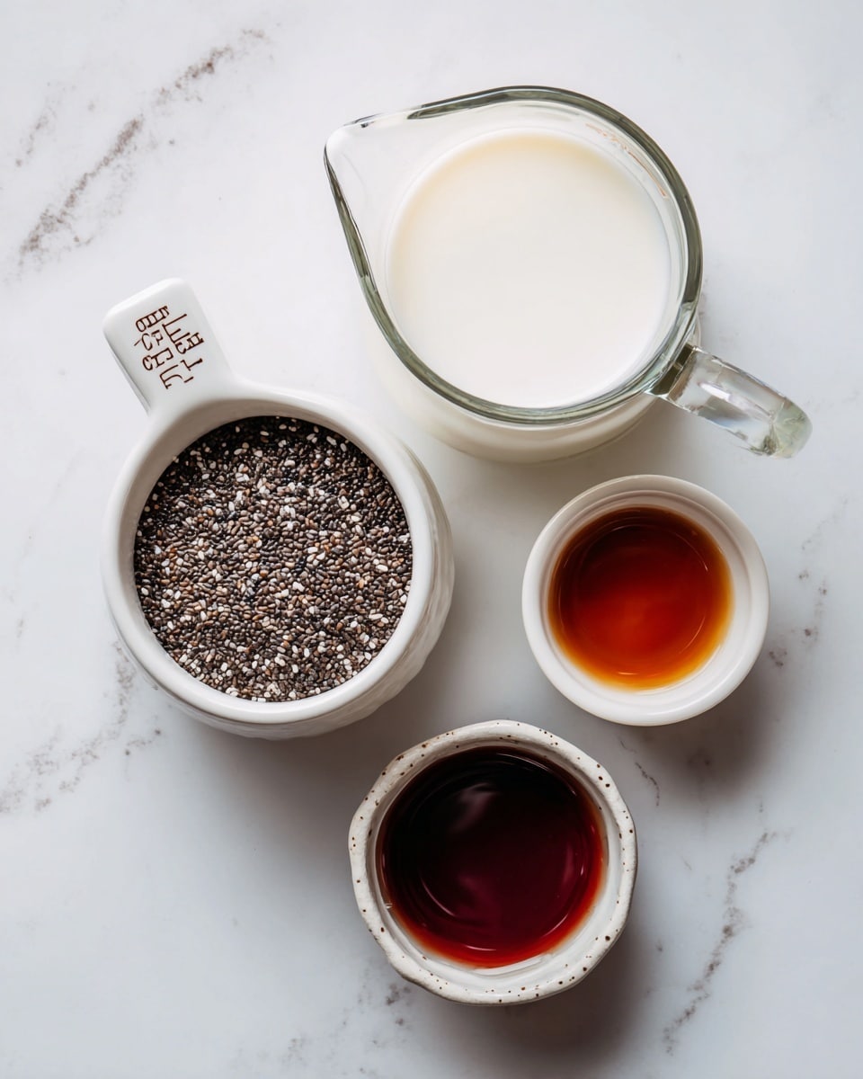 The image shows four containers placed on a white marbled surface. At the top right is a clear glass measuring jug filled with white milk. Below and to the left is a white ceramic measuring cup labeled