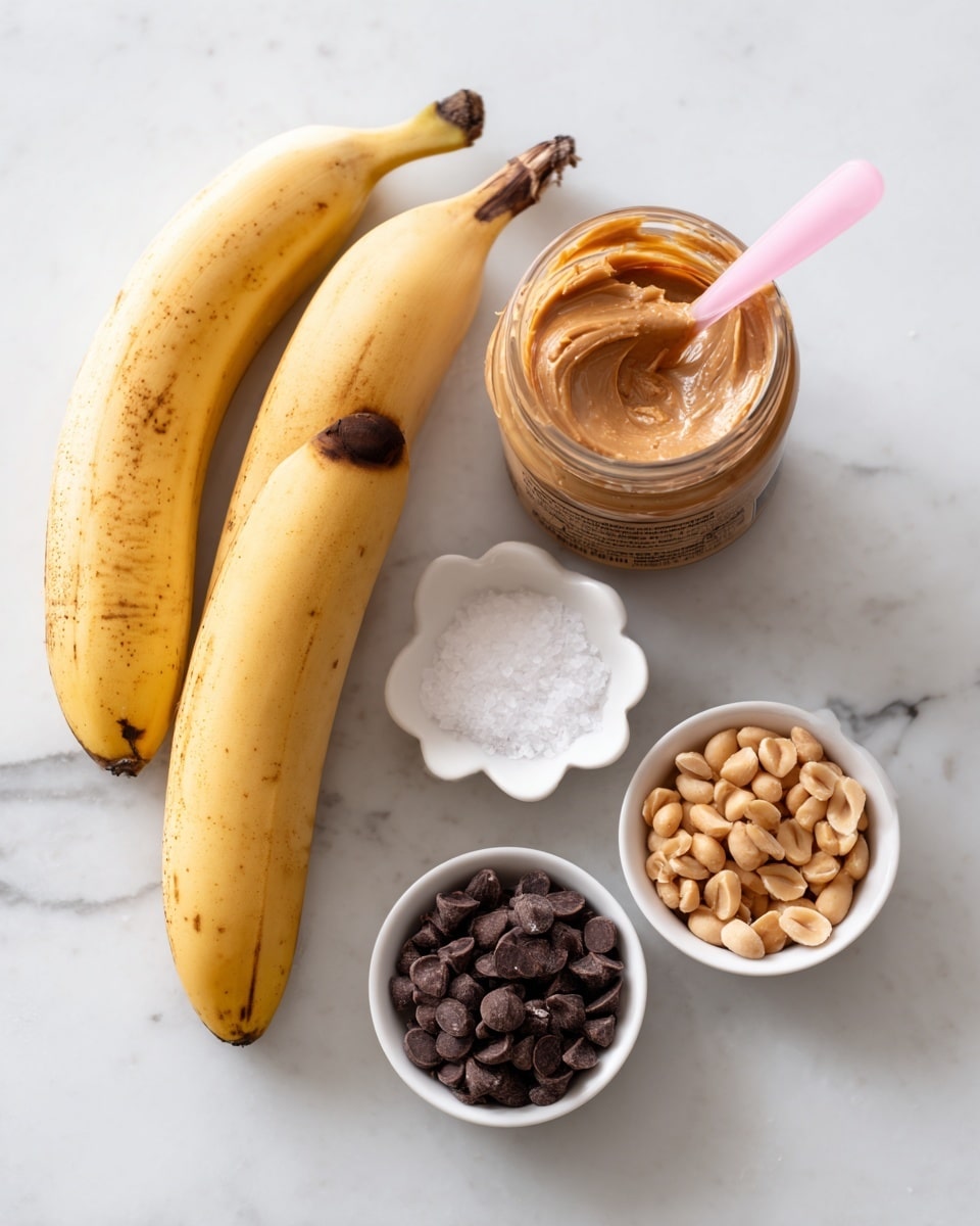 The image shows ingredients for a snack arranged on a white marbled surface. There are two ripe yellow bananas with brown spots near the center. To the left, there is a clear jar of creamy peanut butter with a pink spoon inside, showing the smooth, light brown texture of the peanut butter. Below it is a closed peanut butter jar with a brown lid and a label. On the right side, there are three small white bowls holding different ingredients: one filled with small dark brown chocolate chips at the bottom right, another with light brown peanuts above it, and a small flower-shaped dish with white salt at the top center. photo taken with an iphone --ar 4:5 --v 7