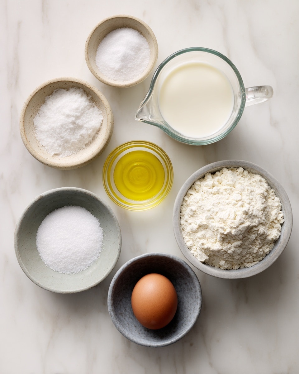 The image shows seven small bowls and a clear glass measuring cup placed on a white marbled surface. From left to right, top row: a small beige bowl with coarse white salt, another small beige bowl with white powder, and a clear glass measuring cup filled with milk. Middle row: a small clear glass cup with light yellow oil and a small gray bowl filled with granulated white sugar. Bottom row: a small gray bowl holding one brown egg and a larger gray bowl filled with white flour. The bowls and cup are arranged neatly with some space between each. Photo taken with an iphone --ar 4:5 --v 7